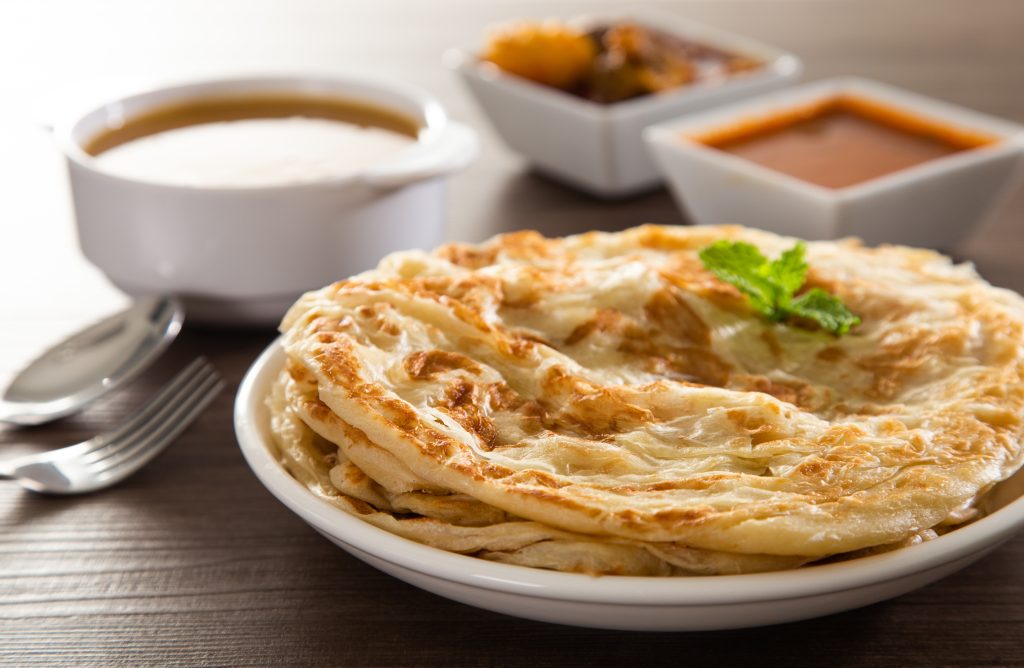 Roti Parata or Roti canai with lamb curry sauce.